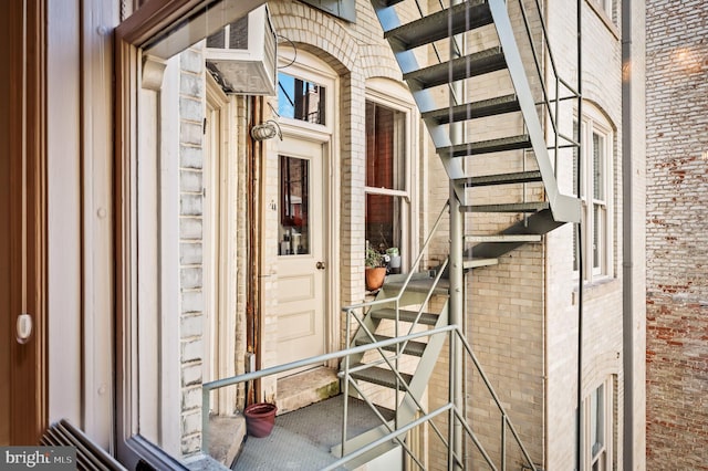 entrance to property featuring brick siding