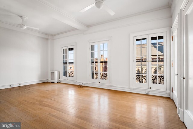 unfurnished room with light wood-type flooring, ornamental molding, ceiling fan, and beamed ceiling