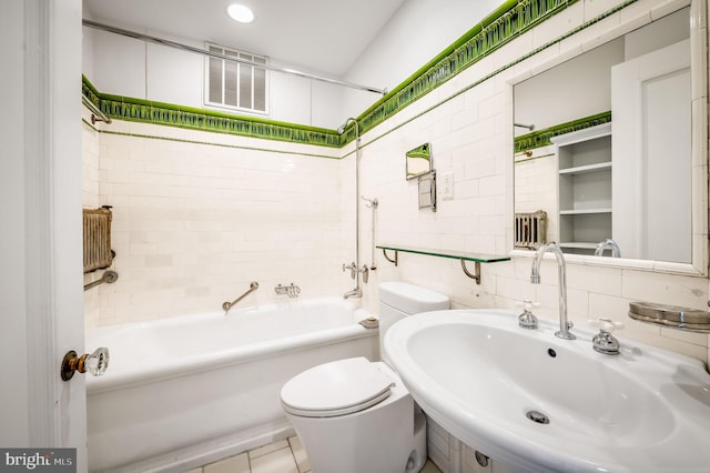 full bath featuring a sink, shower / washtub combination, tile walls, toilet, and tasteful backsplash