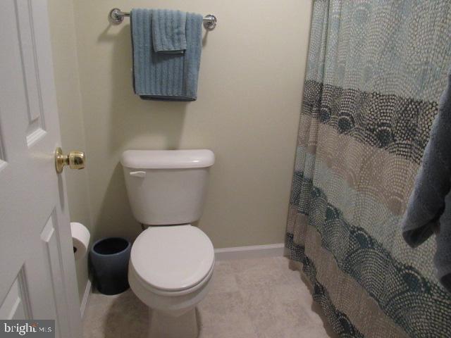 bathroom featuring toilet and walk in shower