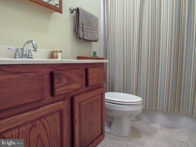 bathroom featuring vanity and toilet