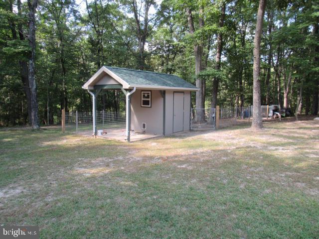 view of outbuilding featuring a yard