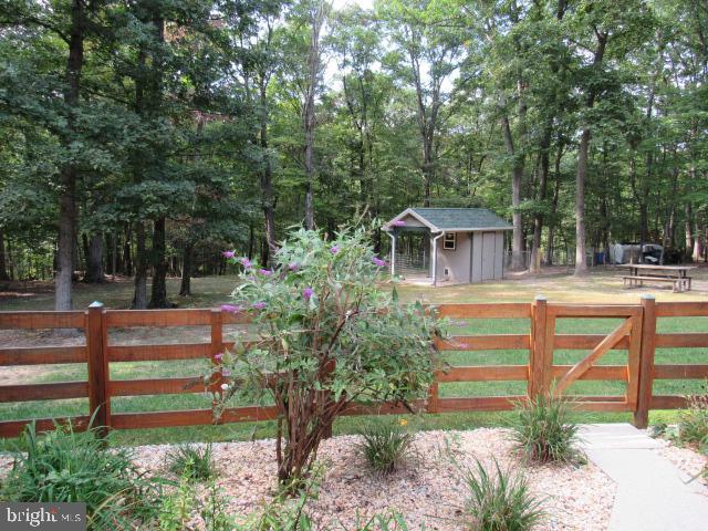 view of gate with a shed