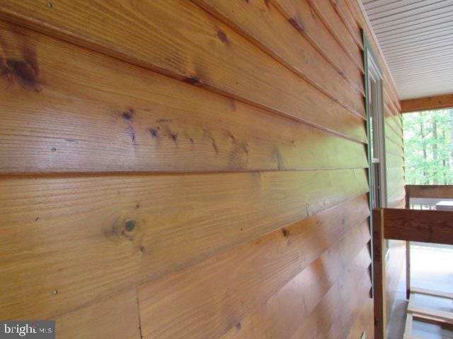 details with wooden ceiling and wood walls