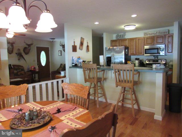 dining area featuring light wood-type flooring and a chandelier