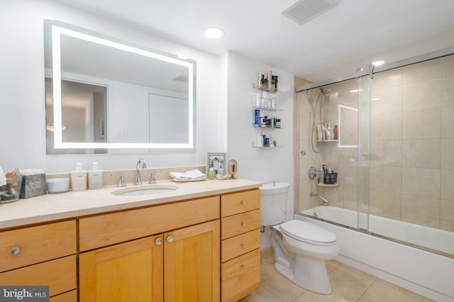 full bathroom with vanity, tile patterned flooring, toilet, and combined bath / shower with glass door