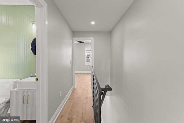 hall featuring light hardwood / wood-style flooring and sink