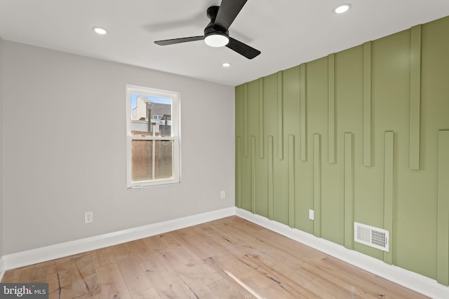 empty room featuring ceiling fan and light hardwood / wood-style flooring