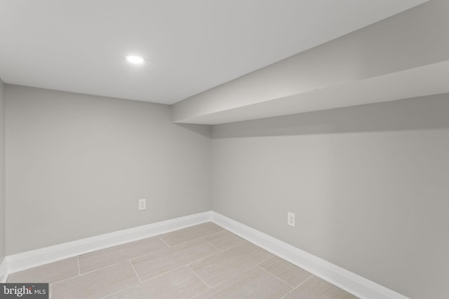 basement featuring light tile patterned flooring