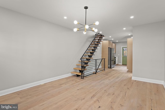 interior space featuring light wood-type flooring and an inviting chandelier