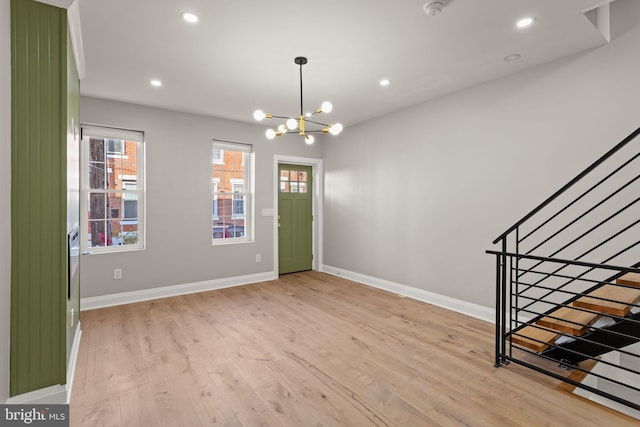 foyer featuring an inviting chandelier and light wood-type flooring