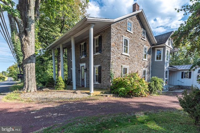 view of property exterior featuring covered porch