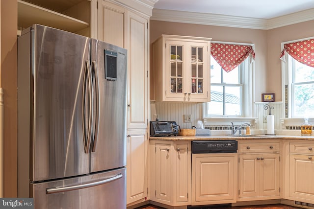 kitchen with light stone counters, ornamental molding, sink, stainless steel refrigerator, and paneled dishwasher