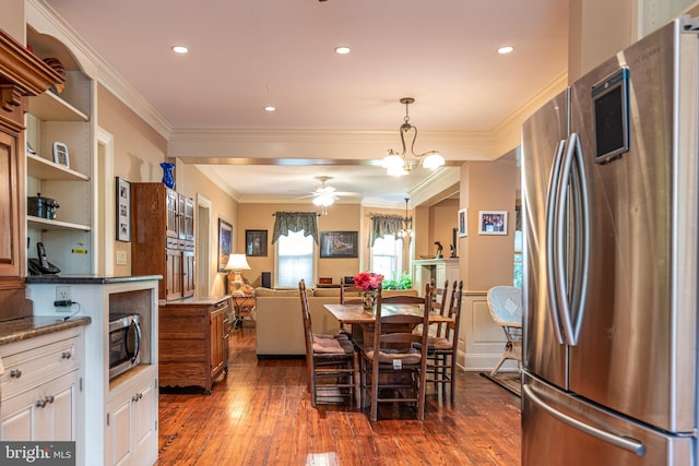 dining space featuring crown molding, dark hardwood / wood-style flooring, and ceiling fan