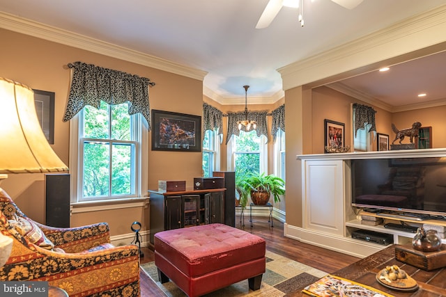 living room with ceiling fan with notable chandelier, crown molding, and dark hardwood / wood-style flooring