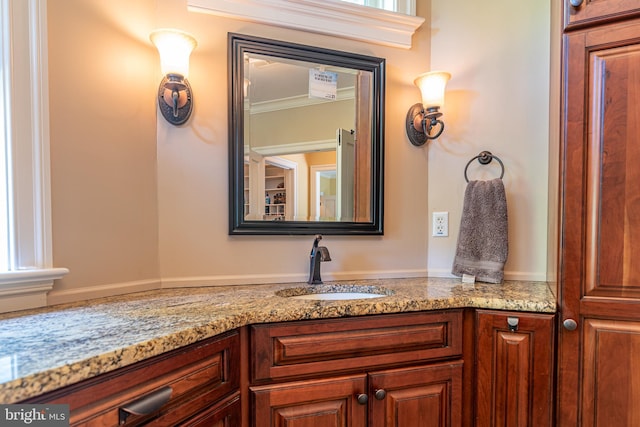 bathroom with ornamental molding and vanity