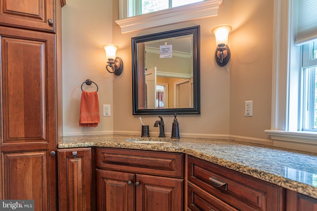 bathroom featuring ornamental molding and vanity