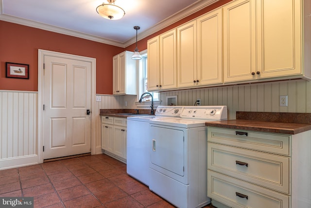 washroom with washing machine and dryer, ornamental molding, sink, and cabinets