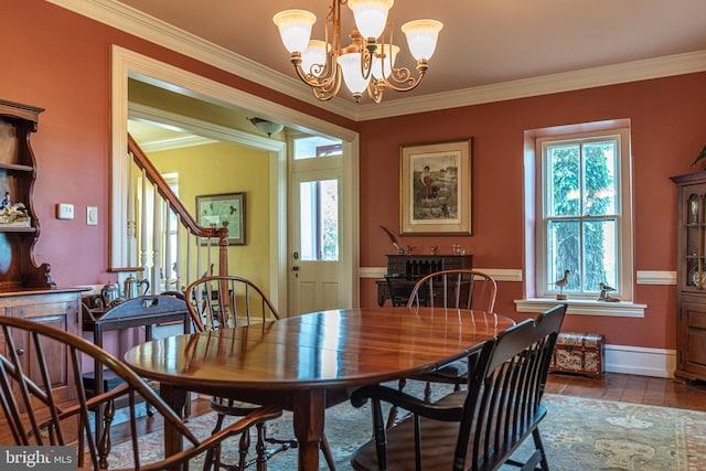 dining area featuring ornamental molding and a chandelier