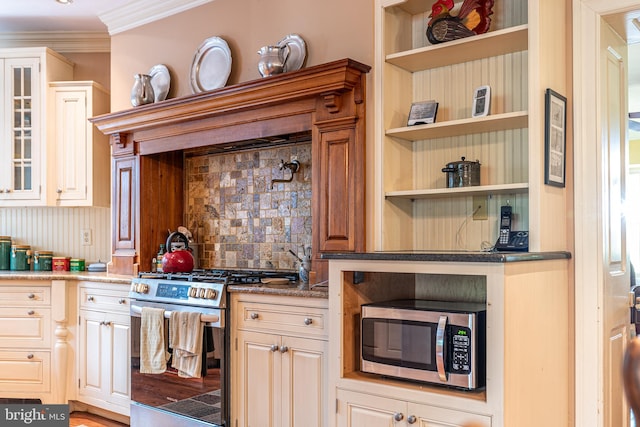 kitchen with light stone counters, tasteful backsplash, stainless steel appliances, wood-type flooring, and ornamental molding