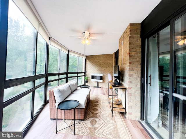 sunroom featuring a ceiling fan