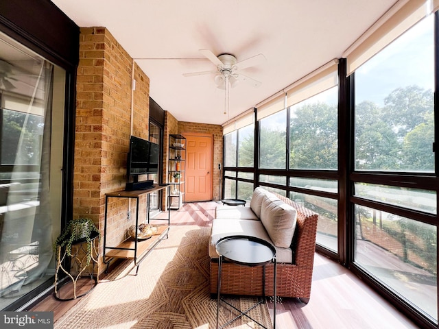 sunroom / solarium featuring ceiling fan