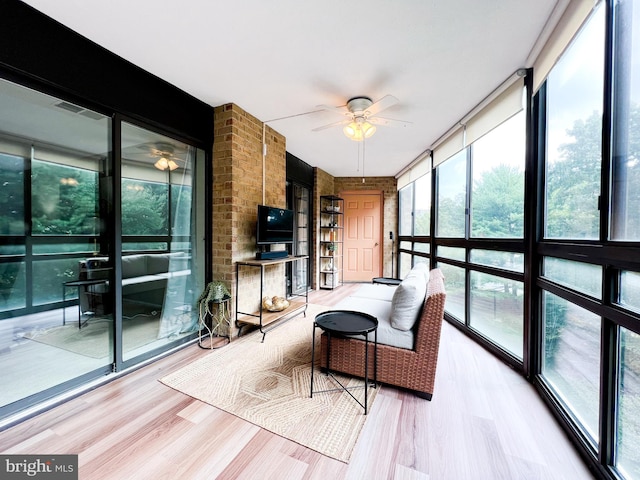 sunroom / solarium featuring ceiling fan