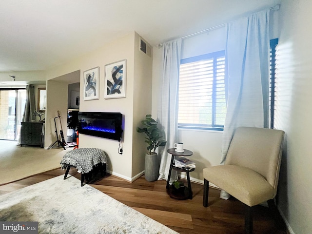 sitting room with wood-type flooring