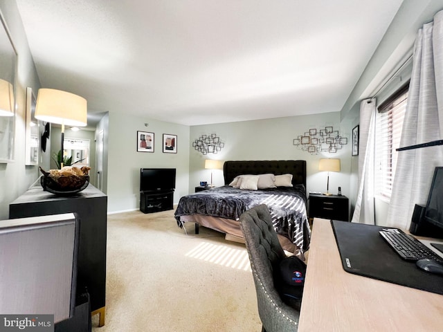 carpeted bedroom with baseboards