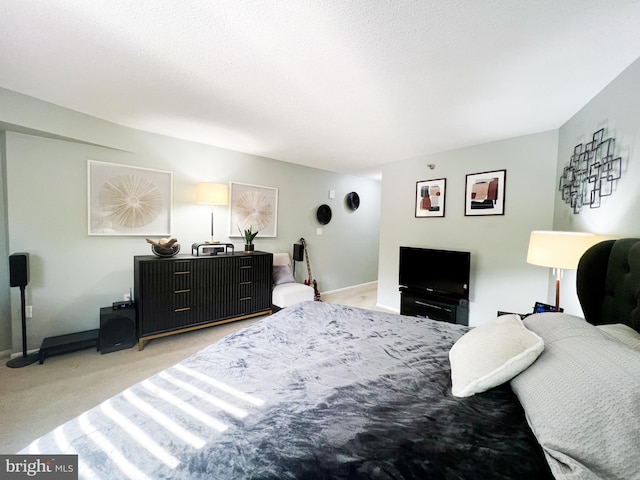 carpeted bedroom featuring baseboards