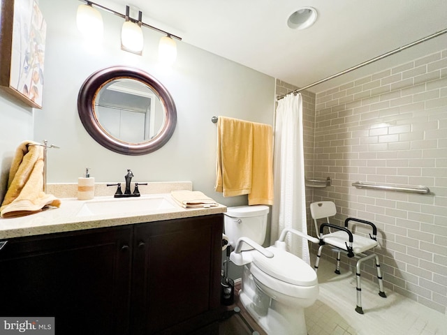 full bath featuring toilet, a tile shower, tile walls, tile patterned flooring, and vanity