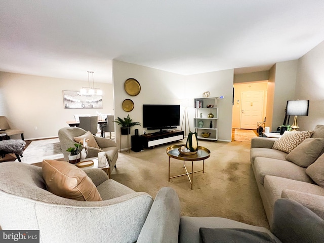 living room with light colored carpet, baseboards, and an inviting chandelier