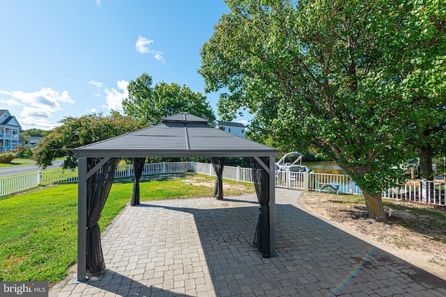 exterior space featuring a gazebo and a water view