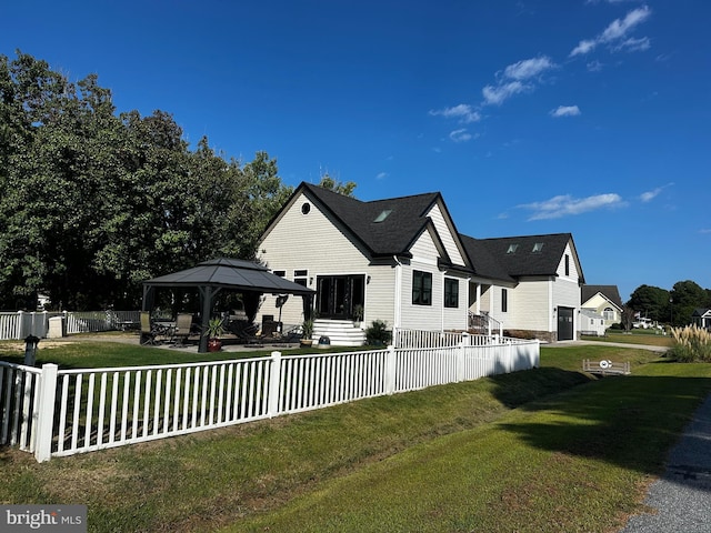 view of home's exterior with a gazebo and a lawn