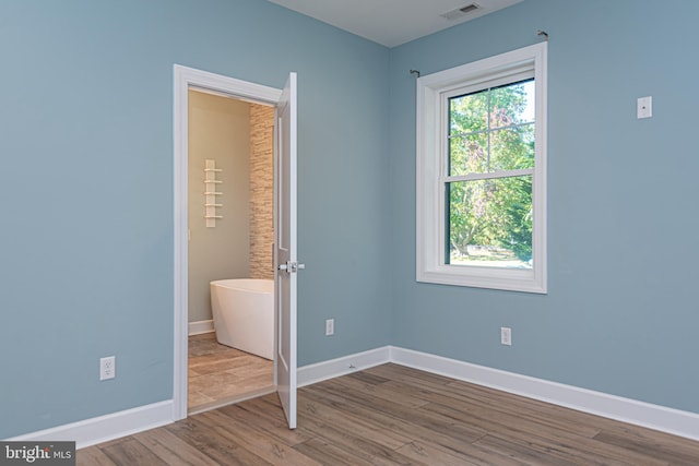 unfurnished bedroom featuring hardwood / wood-style floors