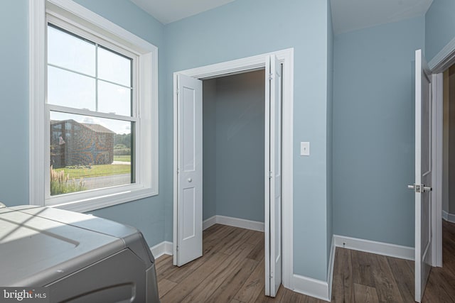 laundry area featuring wood-type flooring