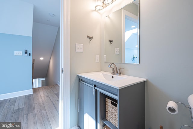 bathroom featuring vanity and hardwood / wood-style floors