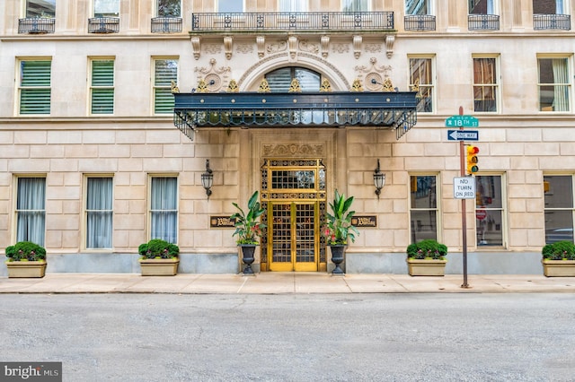 view of exterior entry with a balcony