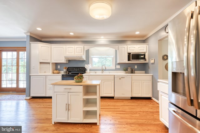 kitchen featuring light hardwood / wood-style flooring, white cabinets, appliances with stainless steel finishes, and ornamental molding