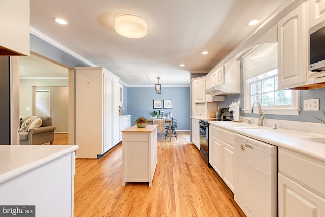 kitchen with decorative light fixtures, electric range, white dishwasher, and white cabinets