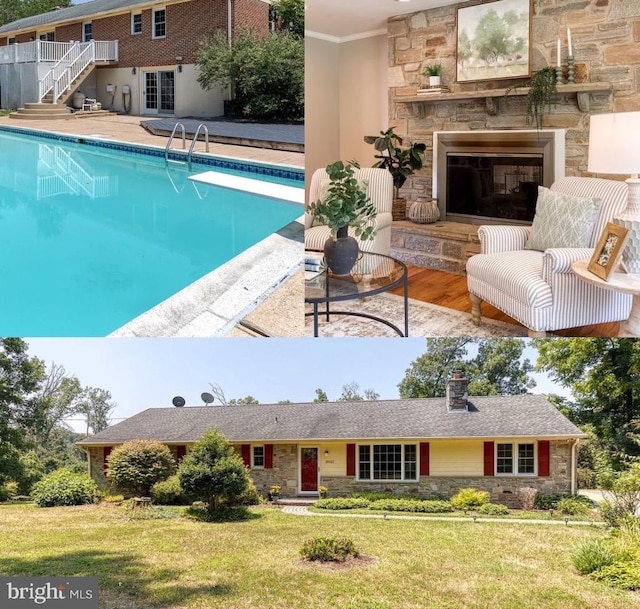 view of pool with a patio, a diving board, a yard, and an outdoor stone fireplace