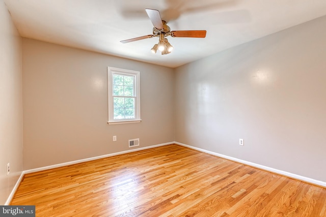 spare room with ceiling fan and light wood-type flooring