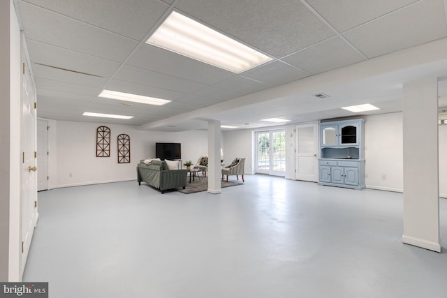 basement with a paneled ceiling