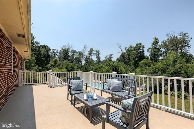 view of patio / terrace featuring a balcony and an outdoor living space