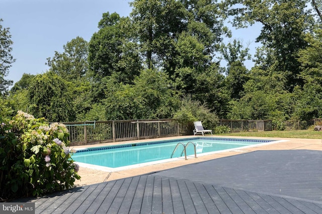 view of swimming pool with a deck