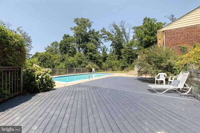 view of swimming pool with a deck