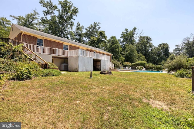 view of yard featuring central AC and a pool side deck