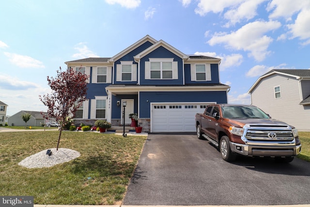 view of front of home featuring a front lawn and a garage