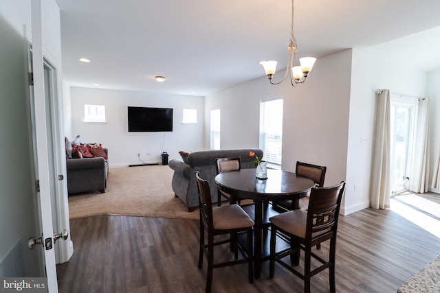 dining area featuring a chandelier and dark hardwood / wood-style flooring