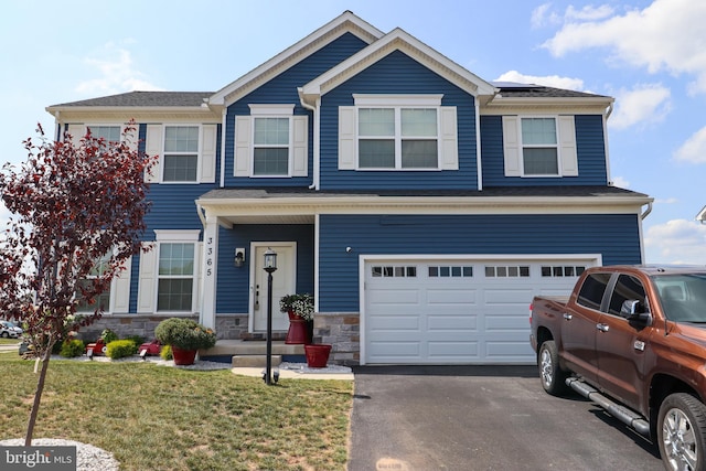 view of front of property with a garage and a front yard